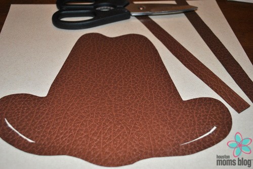 A cut out of the cowboy hat and two strips from the leather textured cardboard. Logo: Houston Moms blog.