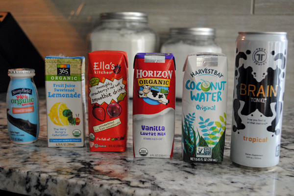 Six drinks including A drinkable yogurt, lemonade, a smoothie drink, milk, coconut water and Brain Toniq.