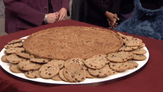 A GIF of a plate of cookies and Cookie Monster with other Muppets and people in the background. 