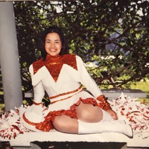 A cheerleader posing for the camera. 
