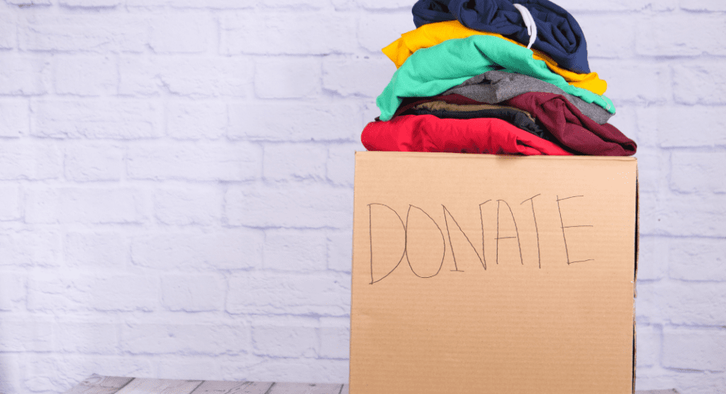 A box labeled Donate containing clothes.
