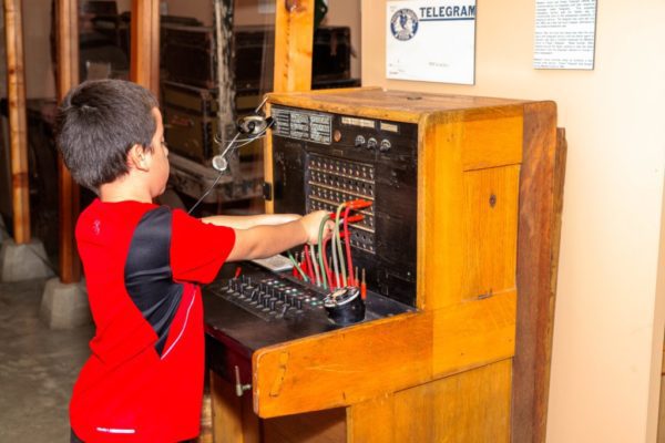 A child playing with a switchboard.