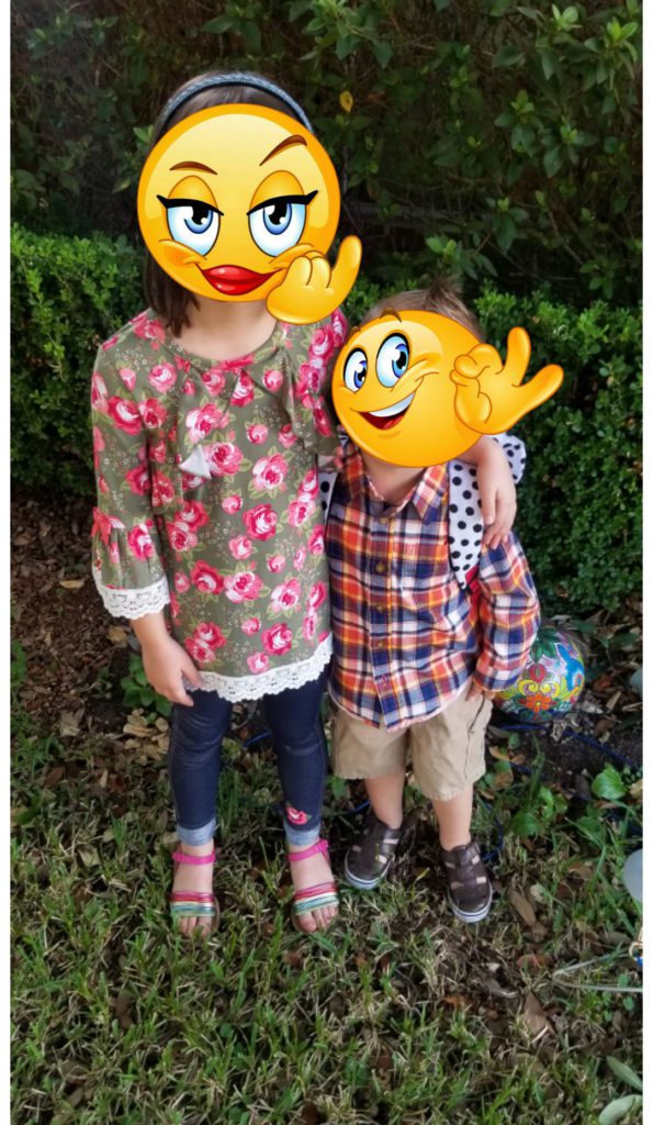 two young foster children with cartoon emojis covering their faces