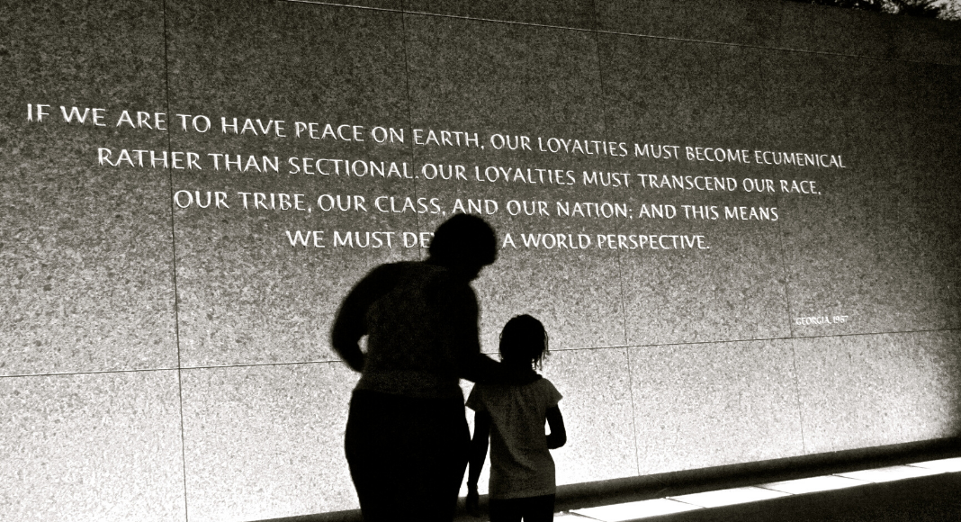 A photograph of a parent and child in front of the Martin Luther King Memorial.