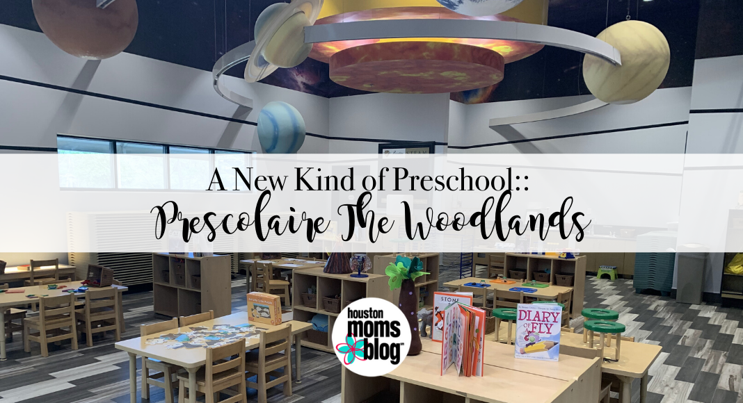 A New Kind of Preschool: Prescolaire The Woodlands. A photograph of a classroom with a large solar system model on the ceiling. Logo: Houston moms blog. 