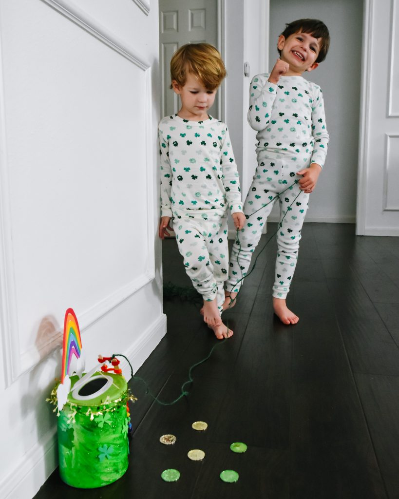 boys in shamrock pajamas admire their leprechaun trap