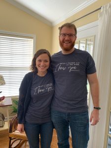A husband and a wife wearing matching shirts. 