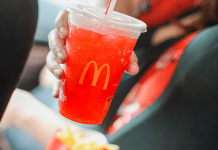 A photograph of a person holding a McDonald's drink.
