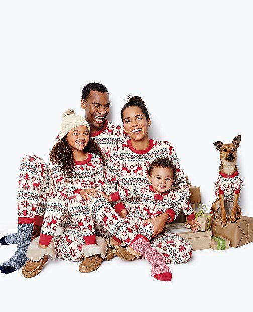 Family of 5 and their dog sitting with white background
