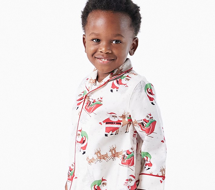 little boy in white button up Christmas pajamas