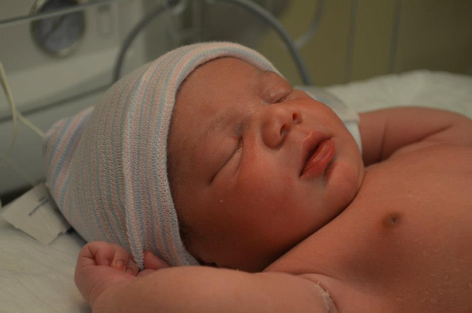 newborn baby boy in hospital cap