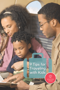 9 Tips for traveling with kids. A photograph of a family of three looking at a book together while on an airplane. Logo: Houston moms. 