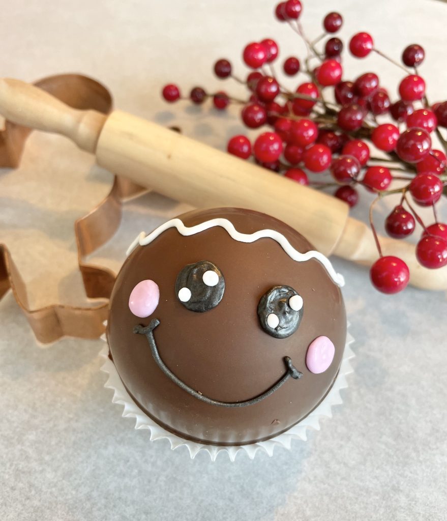 hot chocolate bomb with smily face with rolling pin and cookie cutter 