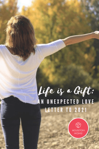 Life is a Gift: An unexpected love letter to 2021. Logo: Houston moms. A photograph of a woman facing away from the camera with her arms outstretched in celebration.
