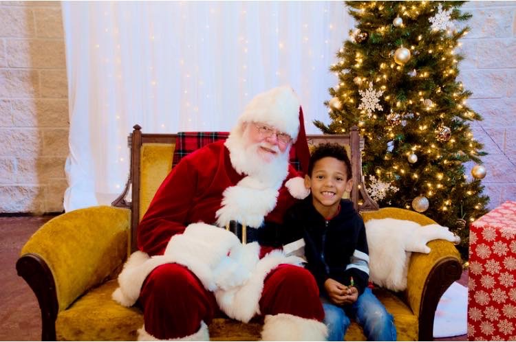 Young boy poses with Santa Claus