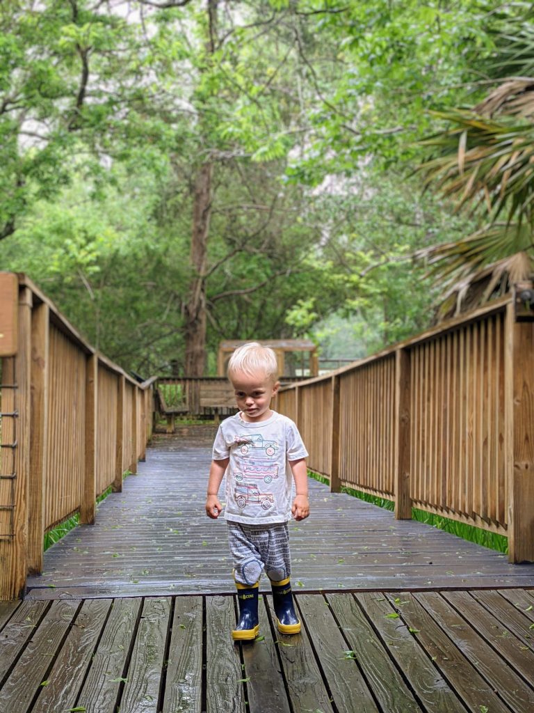 toddler on bridge in nature center