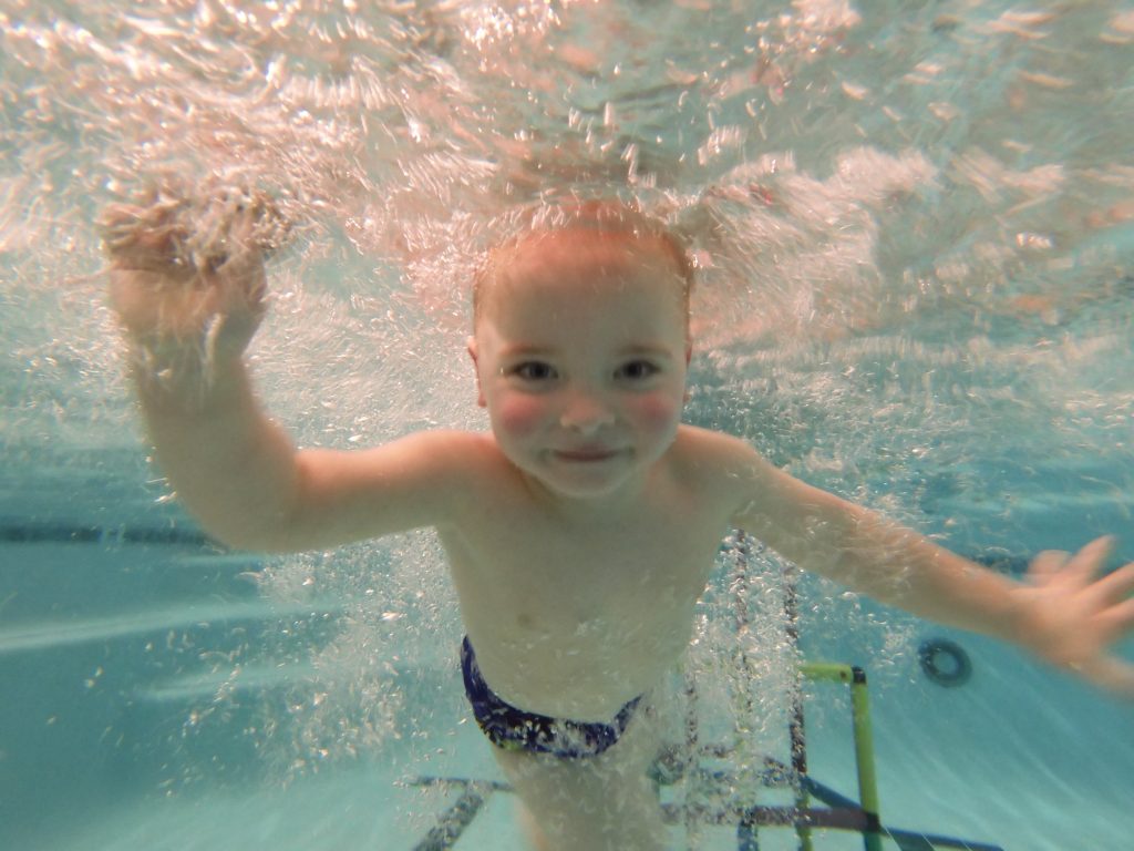 child swims underwater