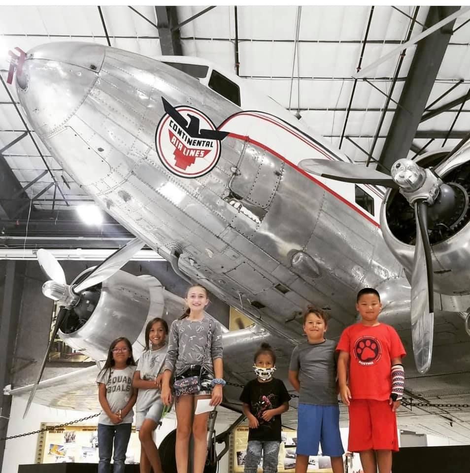children in front of plane at Lone Star Flight Museum