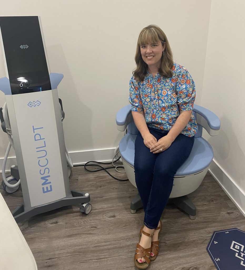 woman sits on EMSELLA therapy chair