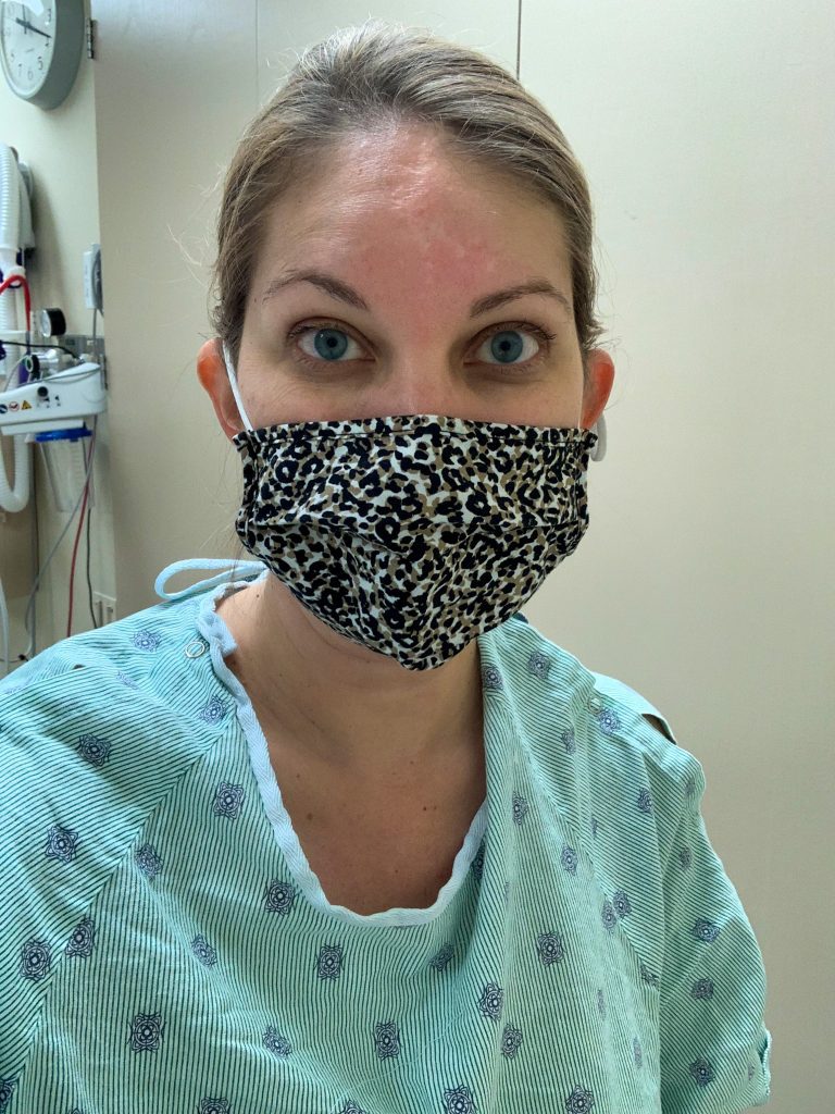 woman in mask and hospital gown at her colonoscopy