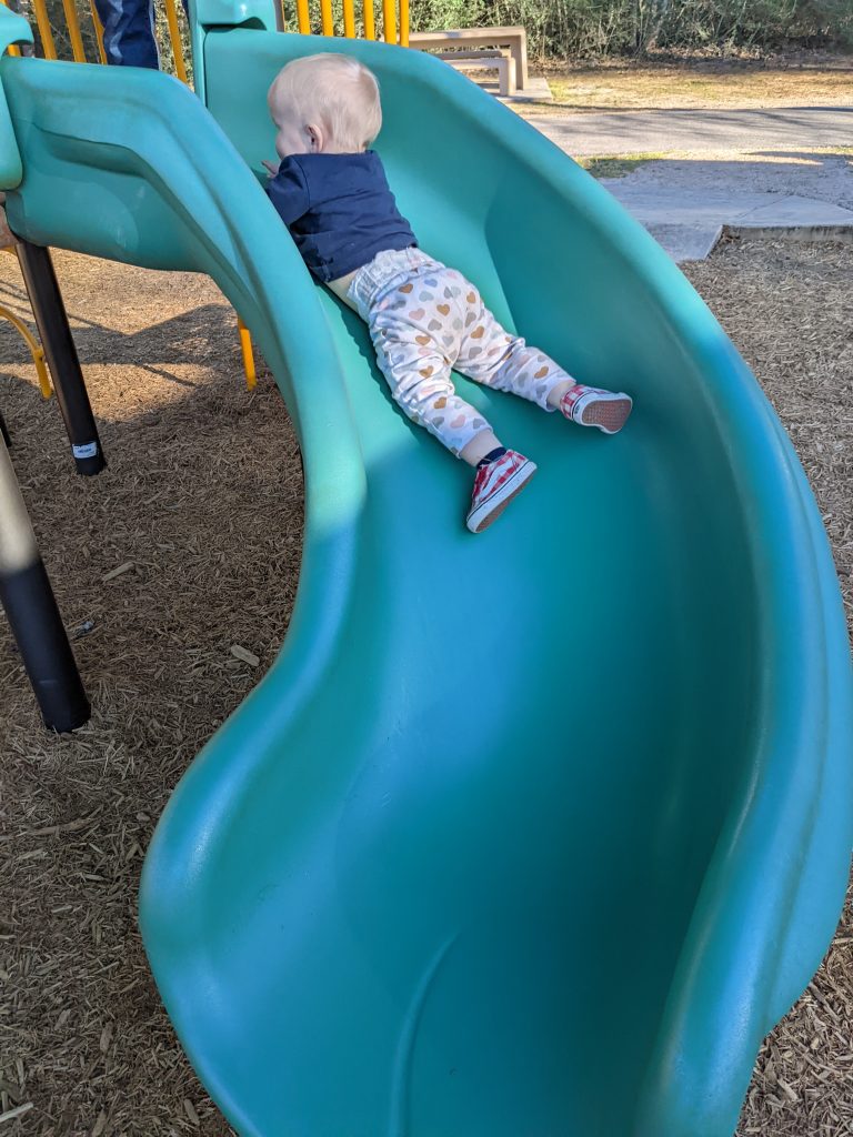 baby on slide at park