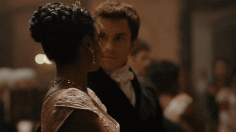 GIF of Bridgerton season 2 characters dancing and staring at each other 