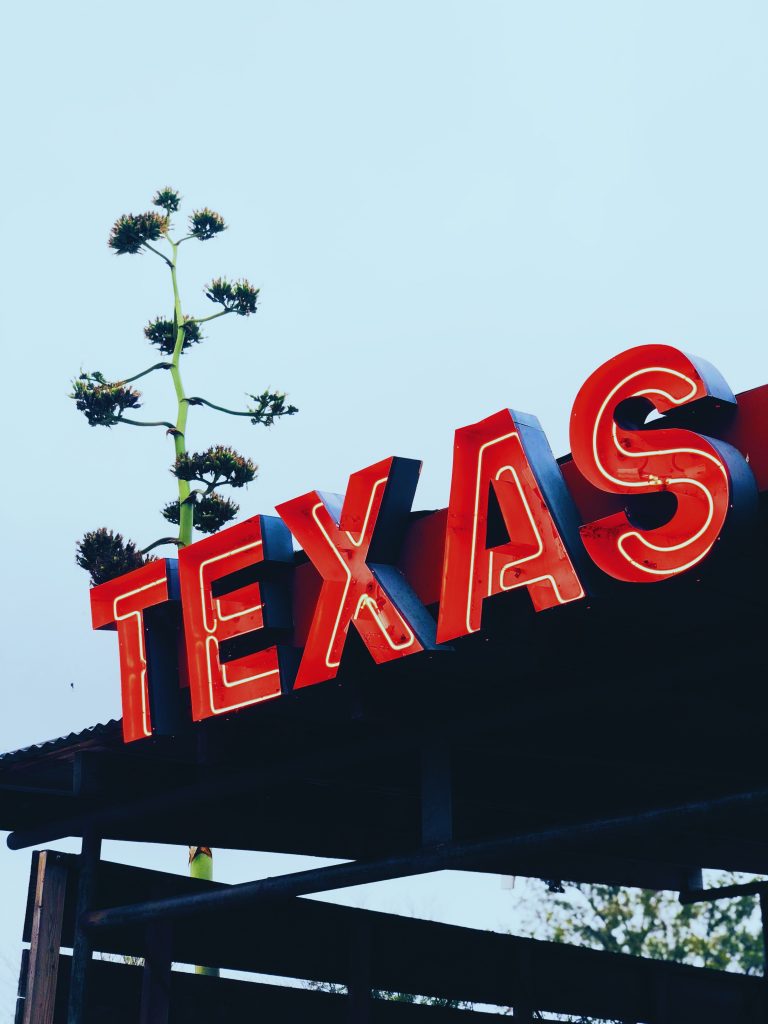 sign that spells TEXAS in red letters