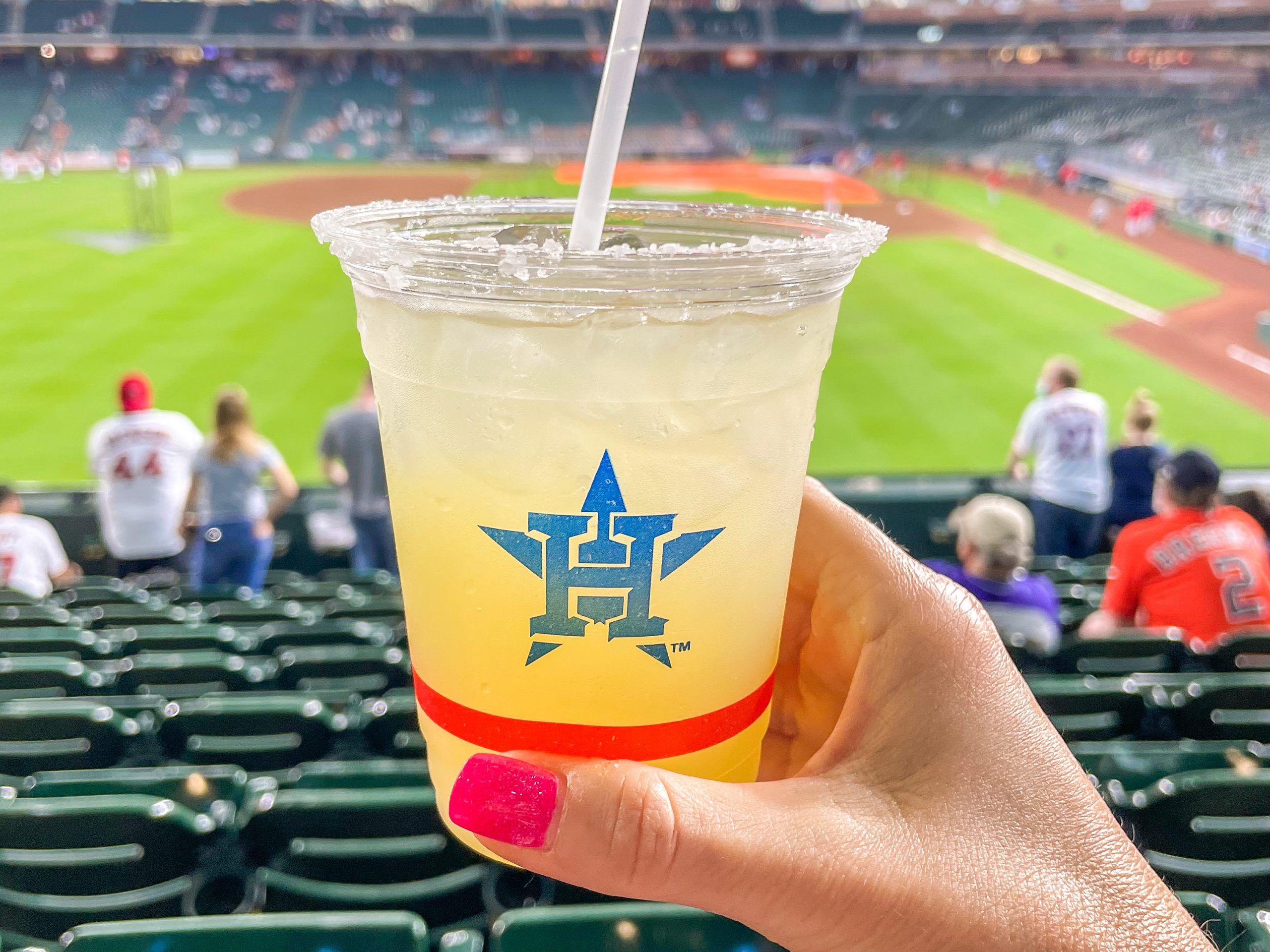 hand holding margarita with Houston Astros logo