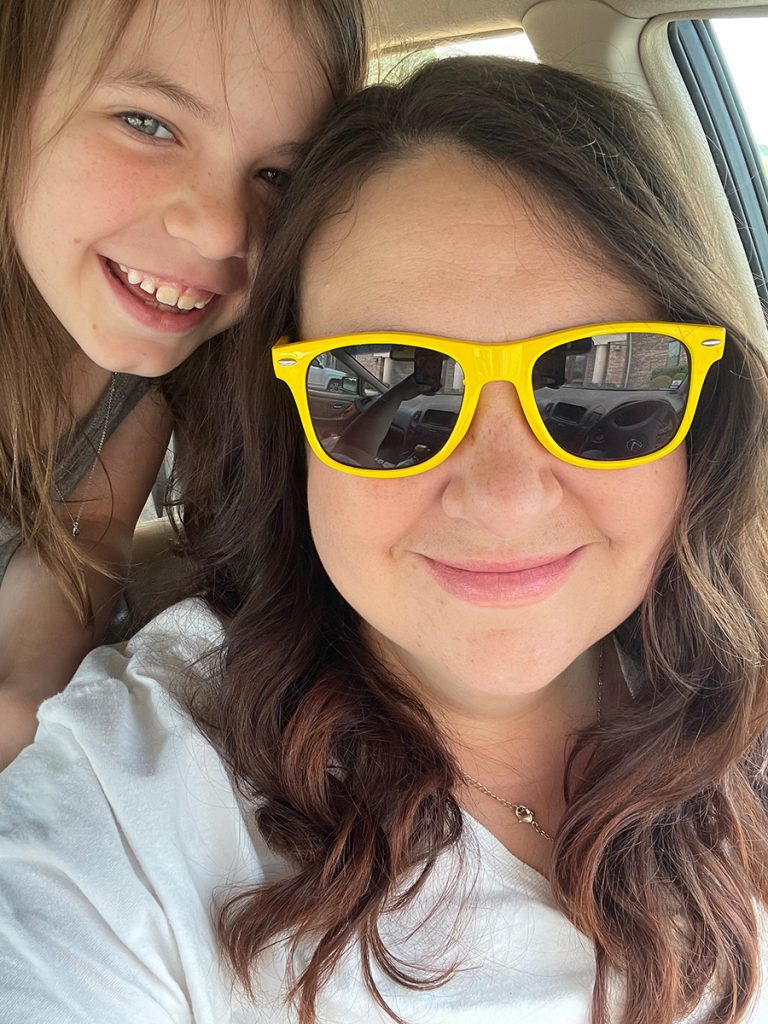 mother in yellow sunglasses poses with young daughter