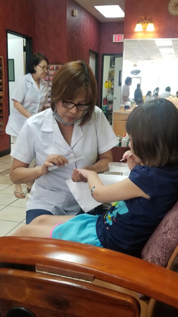 young girl getting a manicure