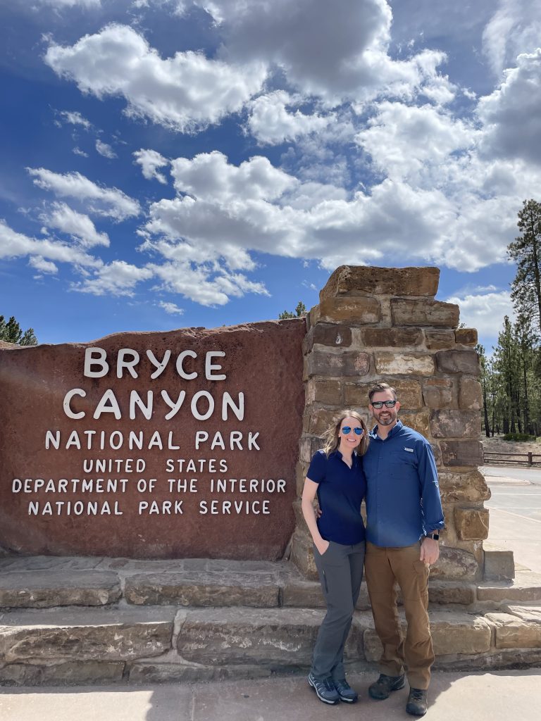 couple standing at the entrance of Bryce Canyon National Park