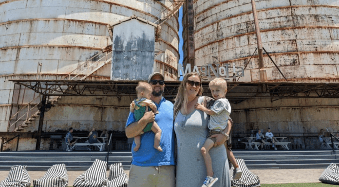 family of four in front of Waco silos