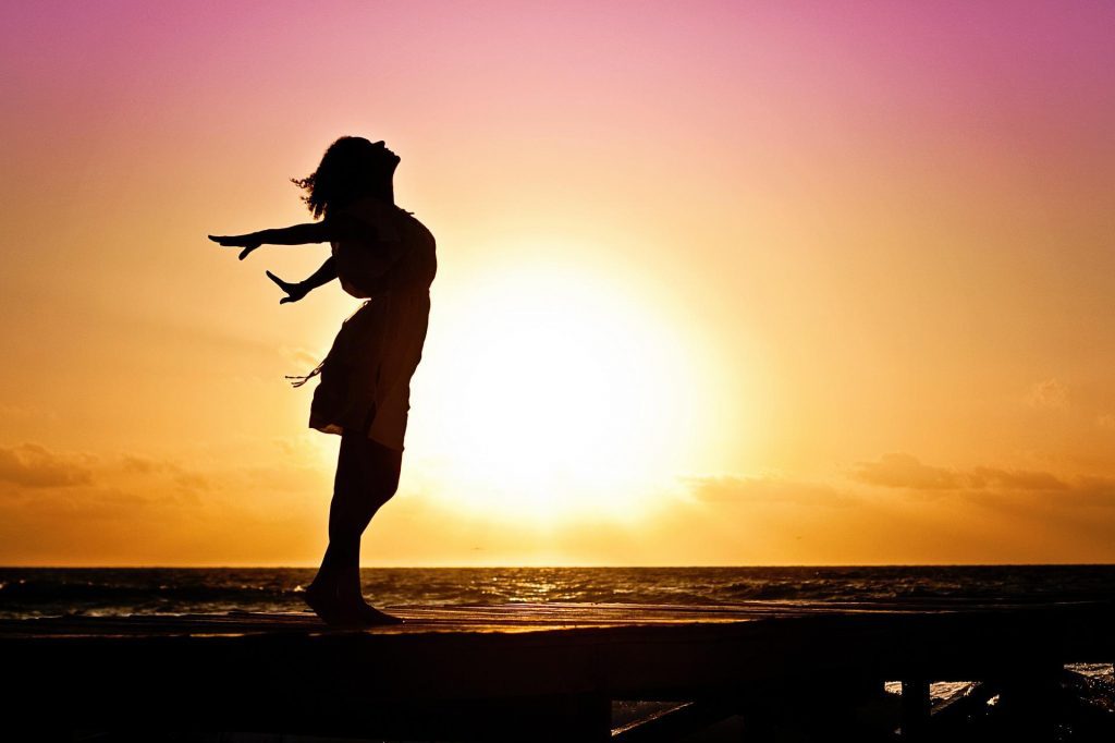 woman in pose in front of sunset
