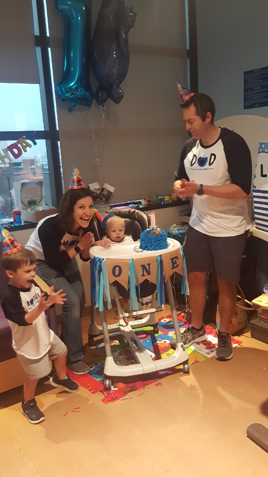 family celebrates a child's first birthday