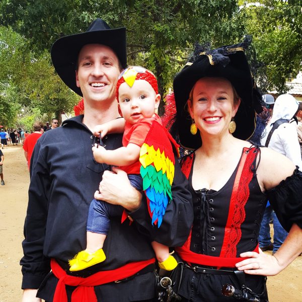 family dressed in pirate attire with baby dressed as a parrot