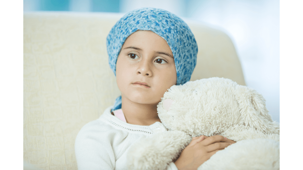 young girl with scarf on head holds stuffed animal