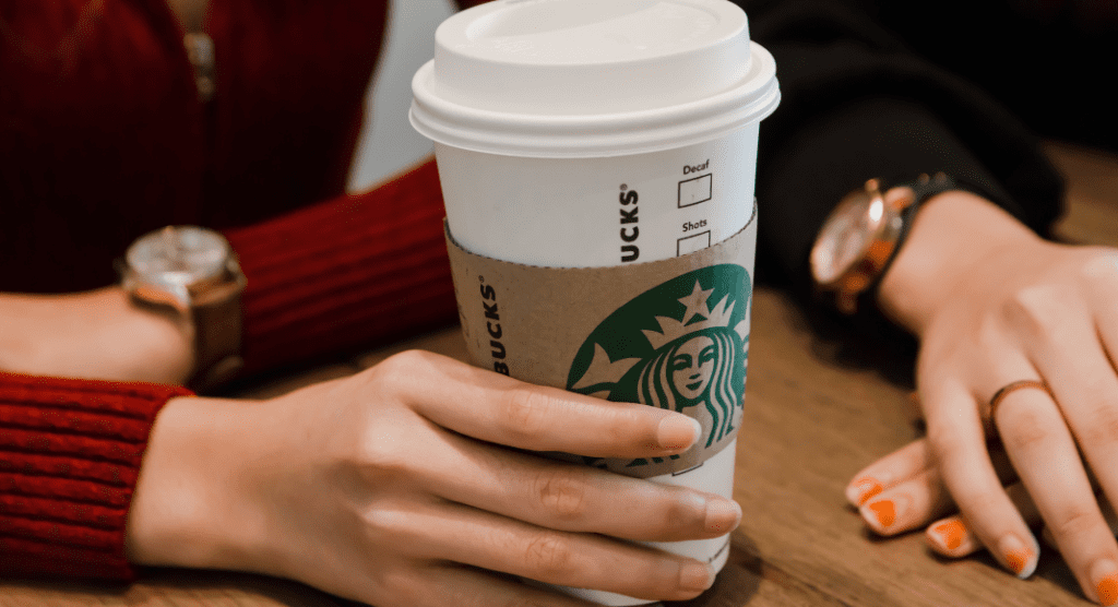 hand holding Starbucks cup