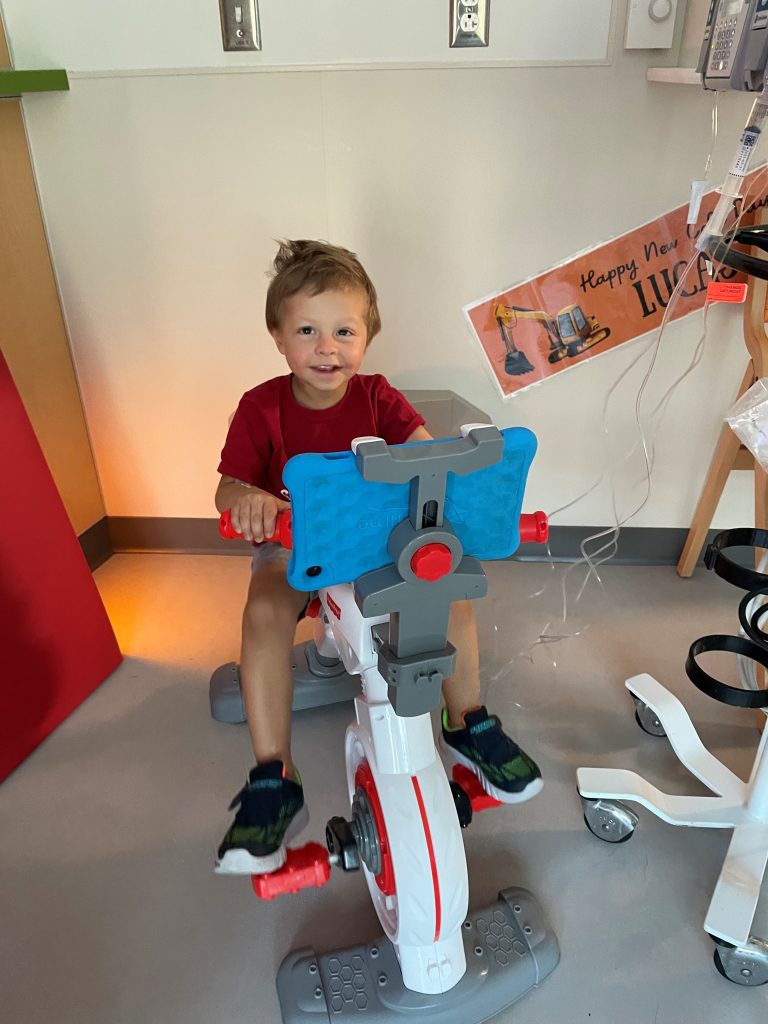 young boy on small exercise bike