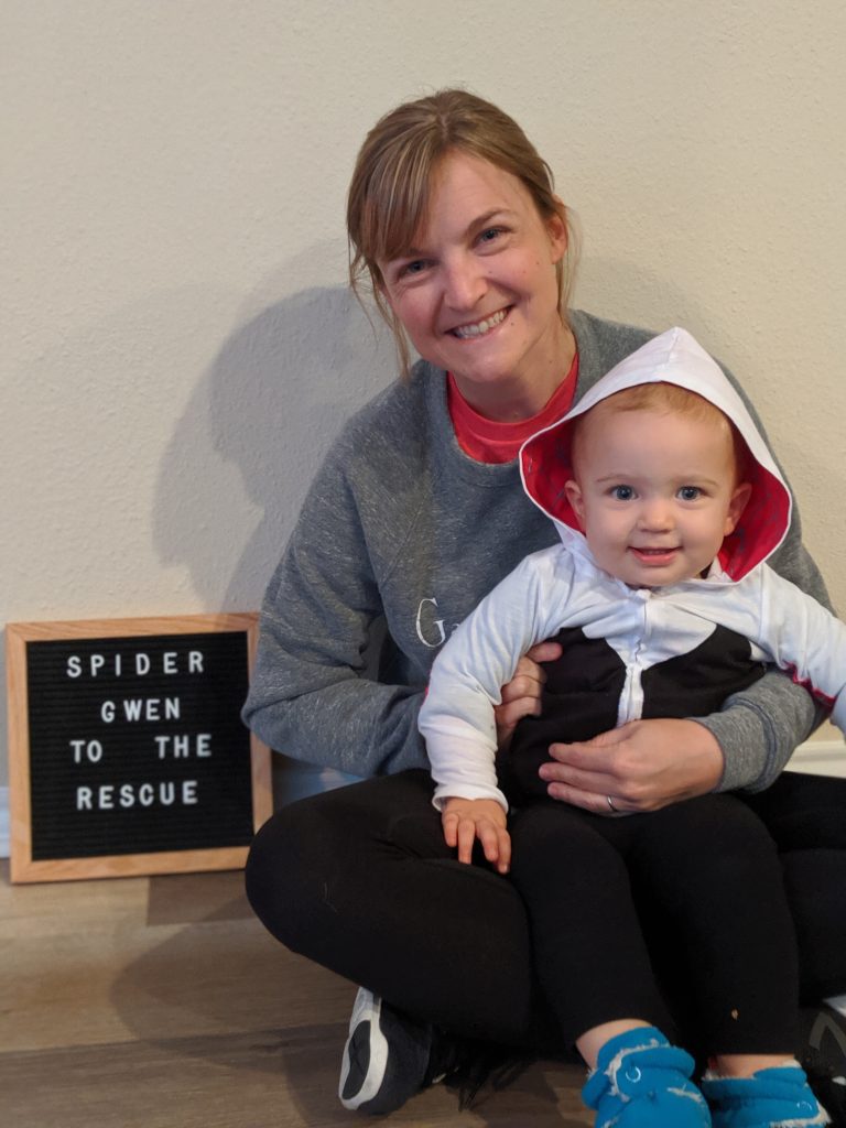baby in Halloween costume sits with mom