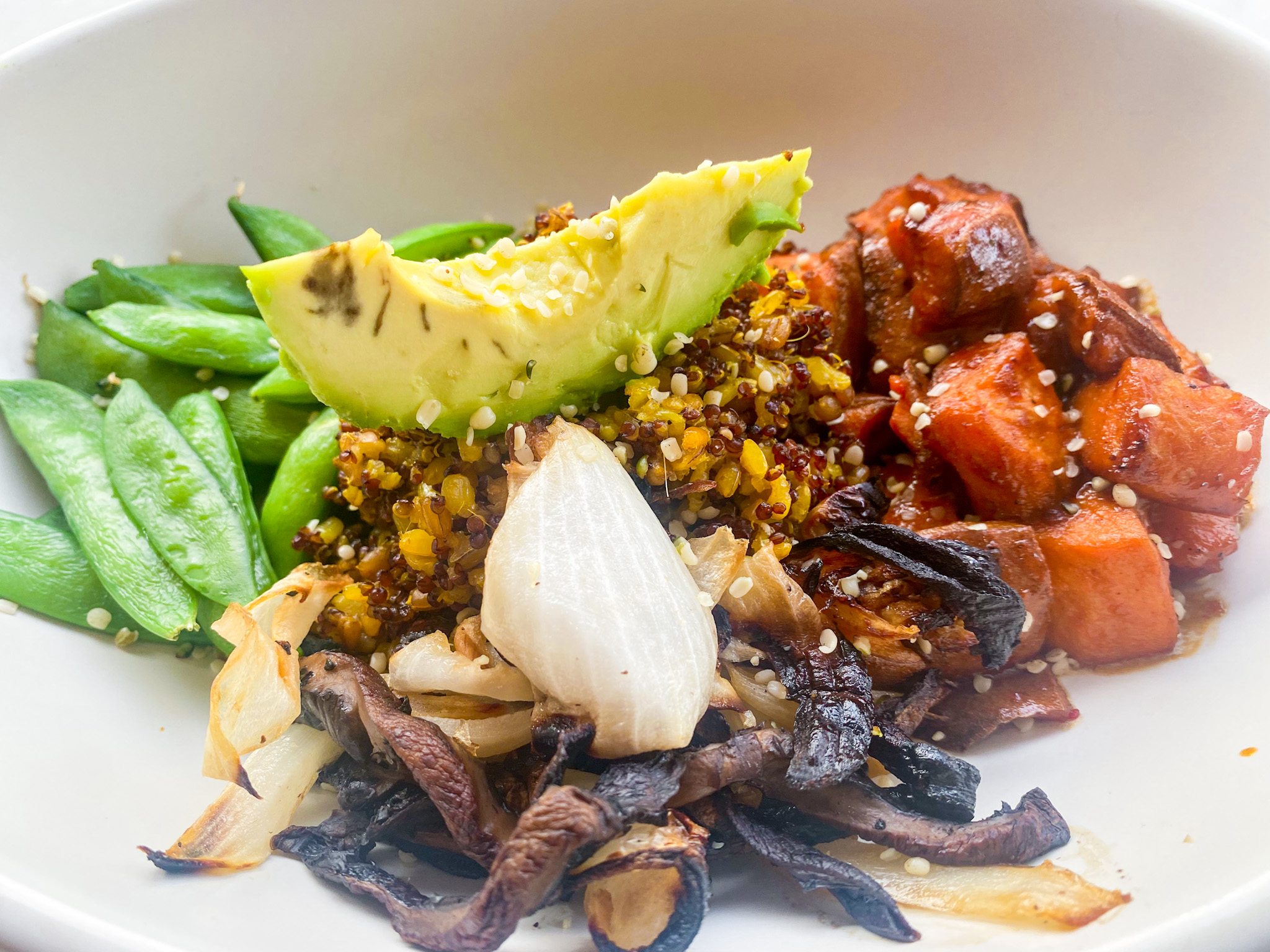 plate of vegetables, grains, and avocado