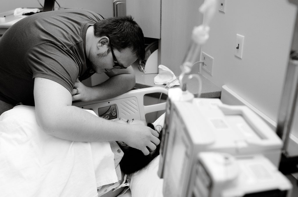 husband comforting wife during childbirth