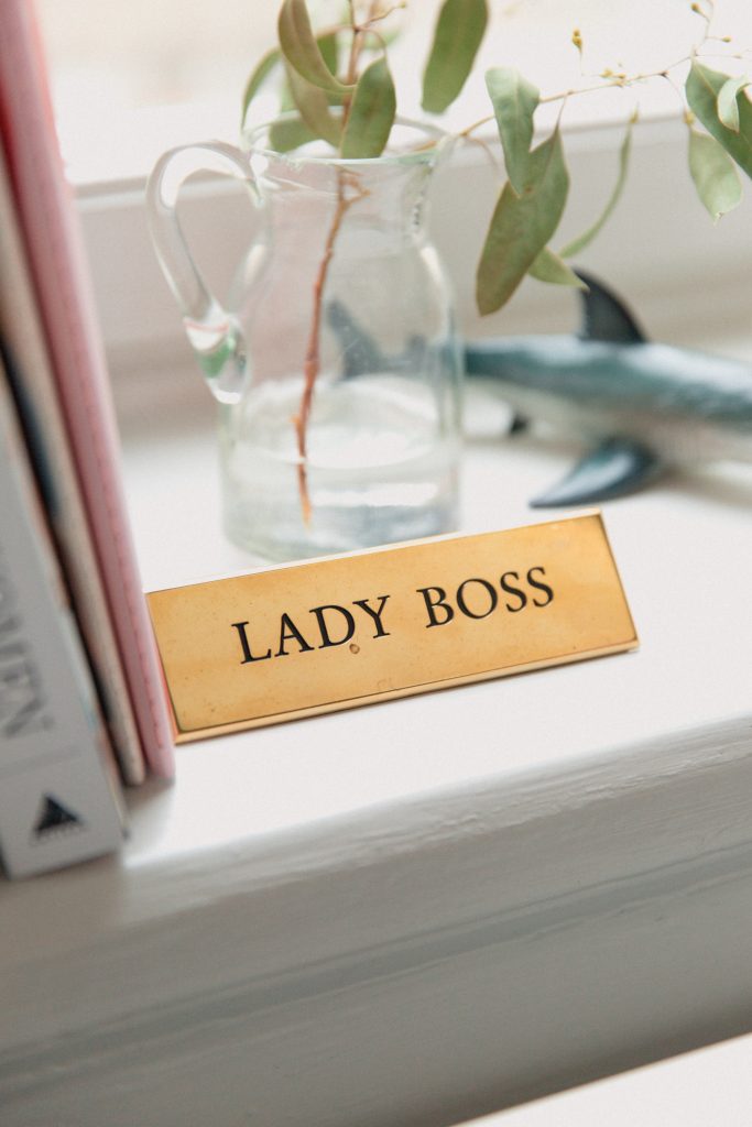 sign by plant that says "Lady Boss"