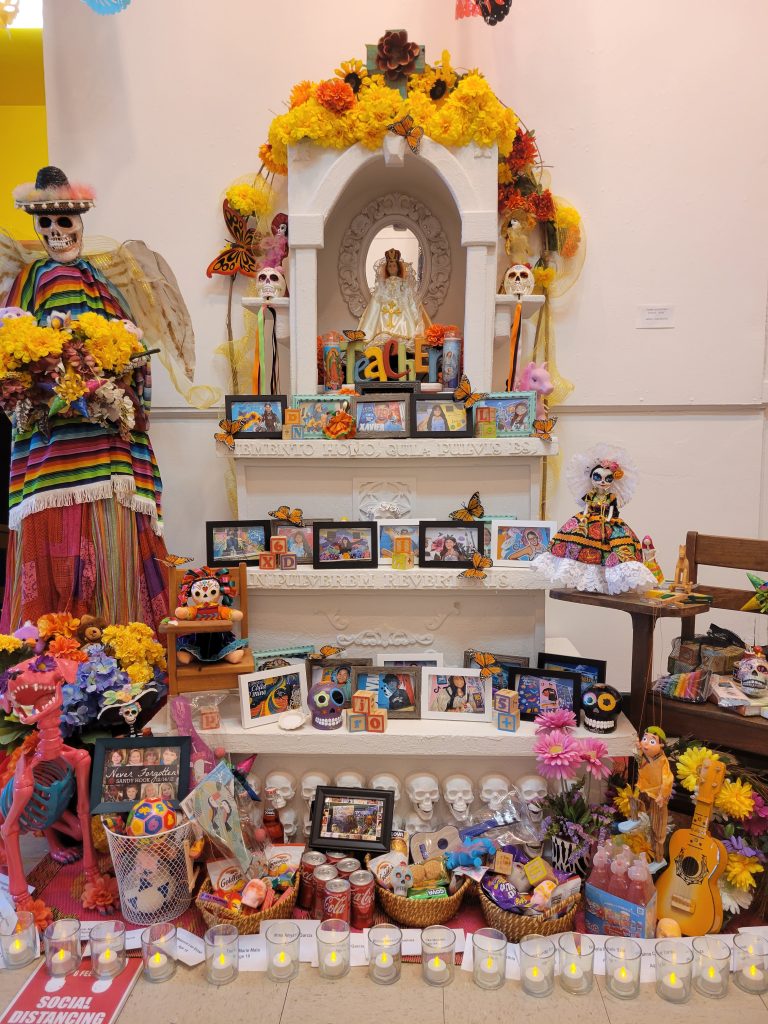 display of framed pictures at the 2022 MECA Houston's Dia de Muertos Festival.