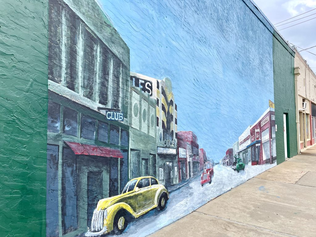 street mural of yellow car in downtown Rosenberg