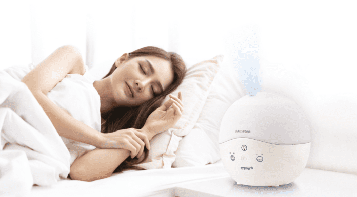 woman sleeps next to aroma therapy device from OSIM