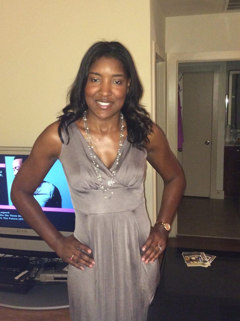 woman in silver dress that shows off her breasts with hands on hips
