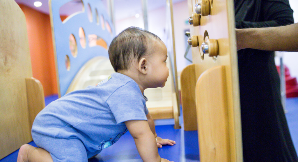 baby crawling in baby gym