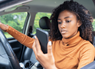 a woman looking at her phone in the car
