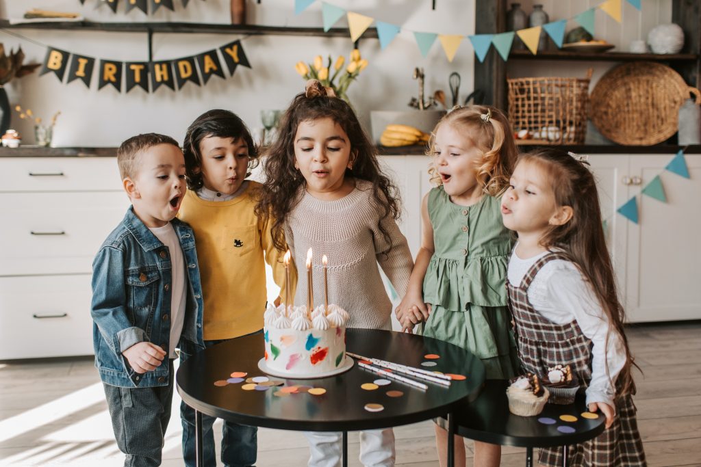 children gathered around birthday cake