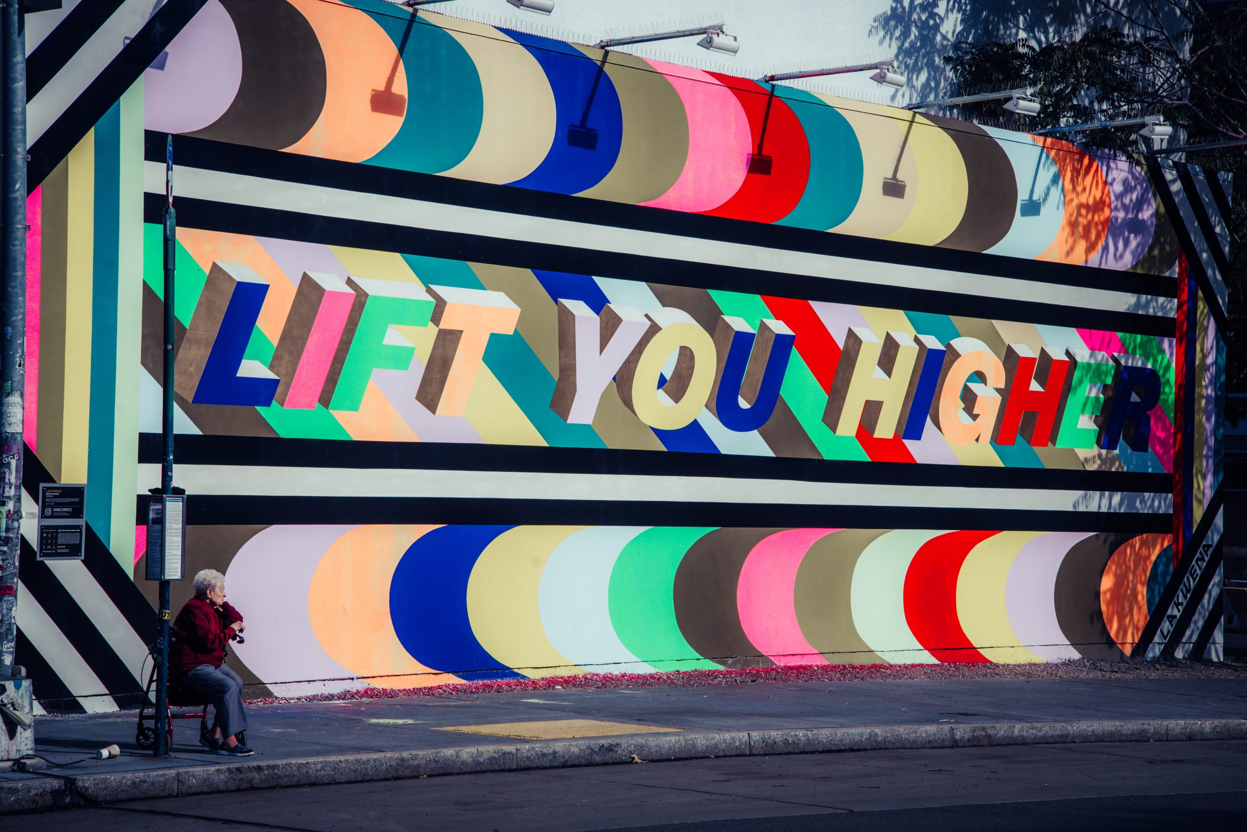 colorful mural that says "Lift You Higher"